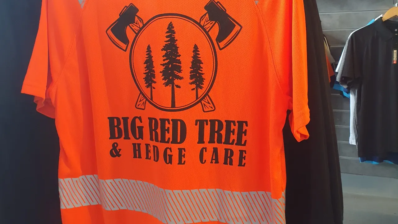 Orange hi-vis t-shirt printed with the Big Red Tree and Hedge Care logo on the back