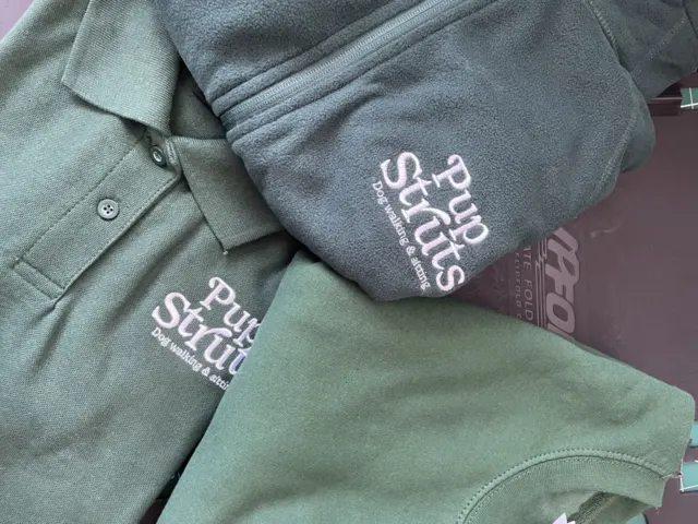 Green polo shirt, sweatshirt and fleece with a white Pup Struts logo