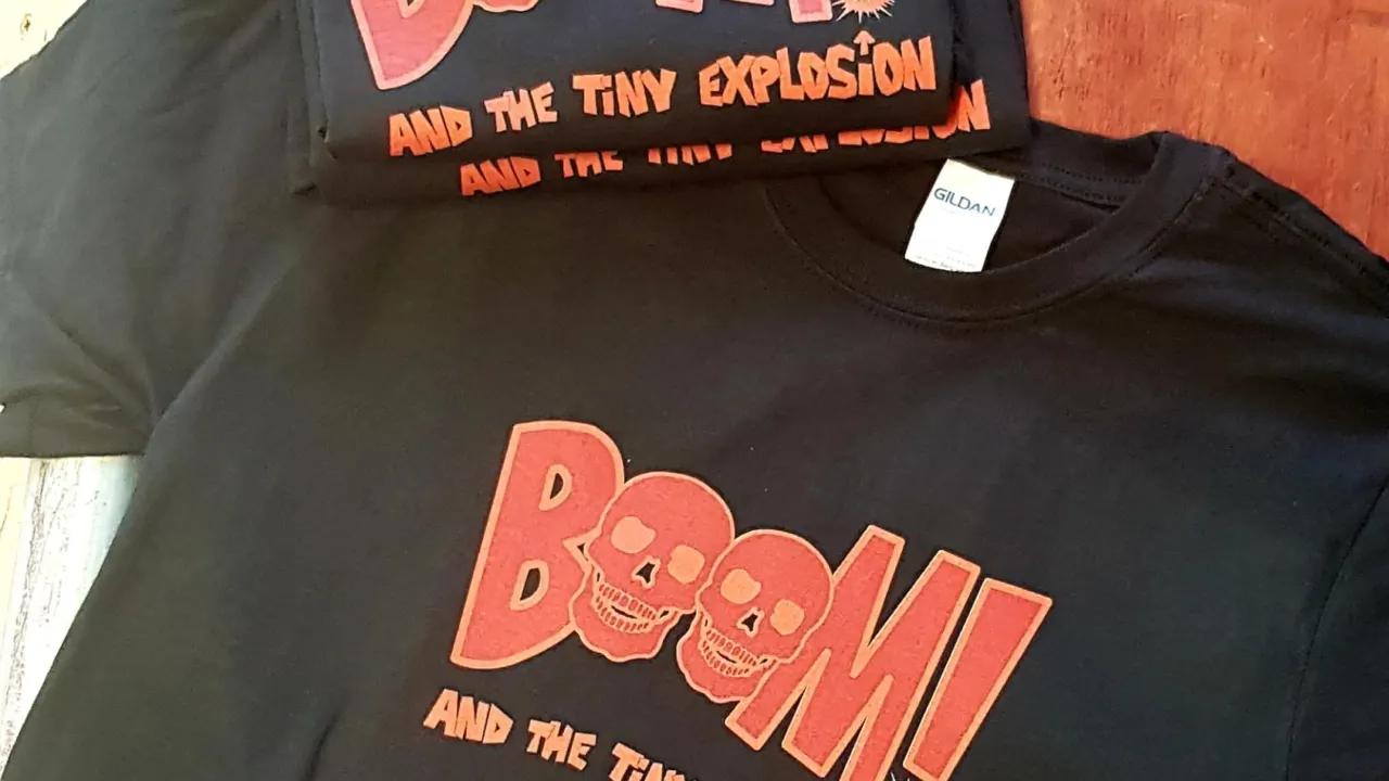 Black t-shirts printed with a red band logo with skulls