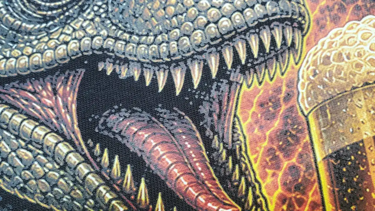 Close-up of a DTF halftone print of a raptor with a pint
